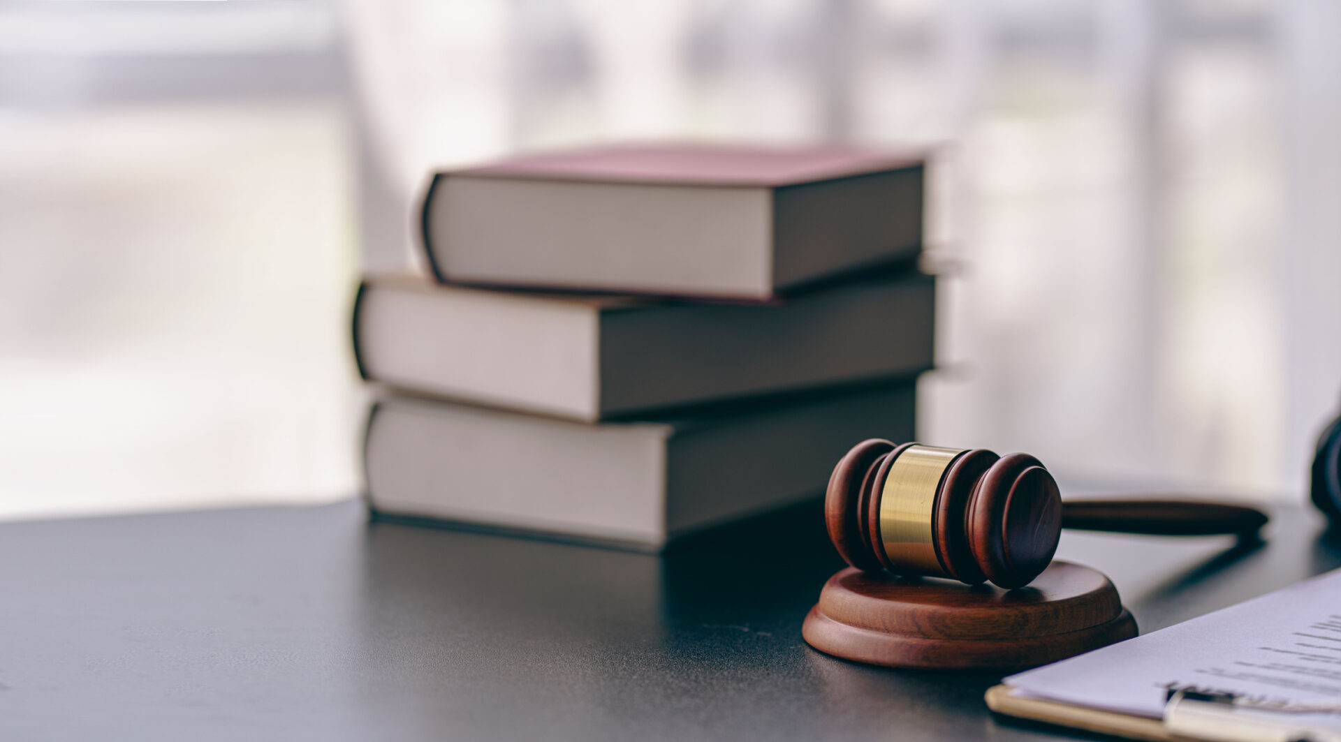 Lawyer or judge's hammer in court The auction hammer is on the woo table. Legal subject or auction company with book sign in office