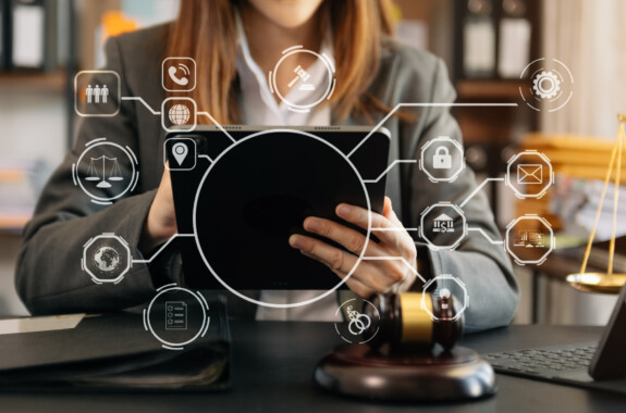 justice and law concept.Male judge in a courtroom the gavel, working with smart phone and laptop and digital tablet computer on with virtual icon