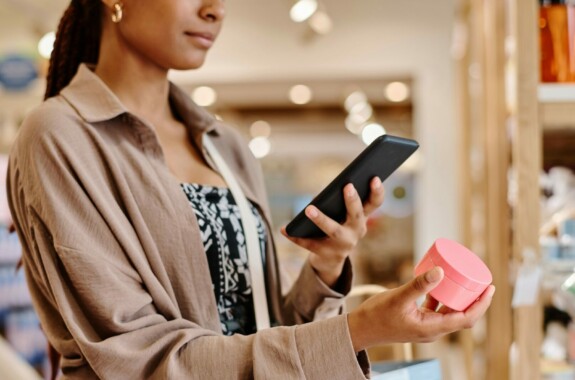 a woman taking a photo of a cosmetic product