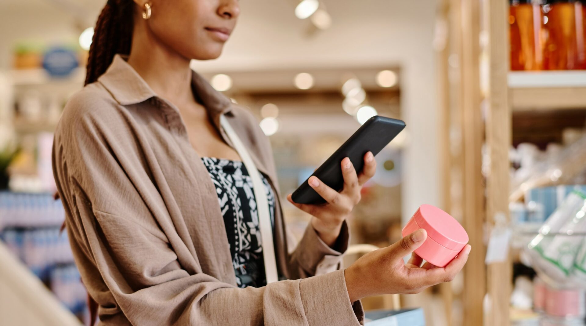 a woman taking a photo of a cosmetic product